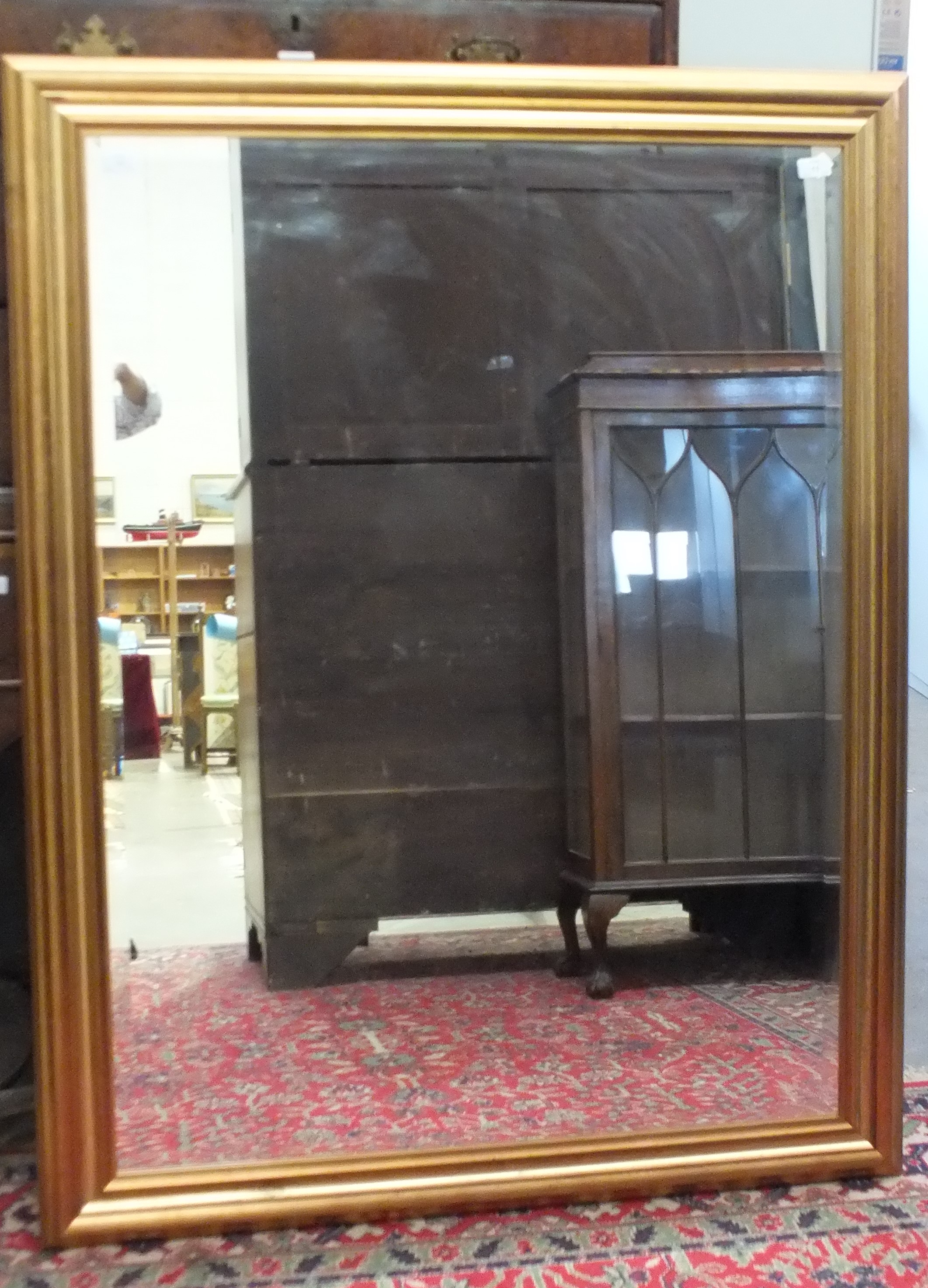 A large modern gilt frame hanging wall mirror, 105 x 138cm.