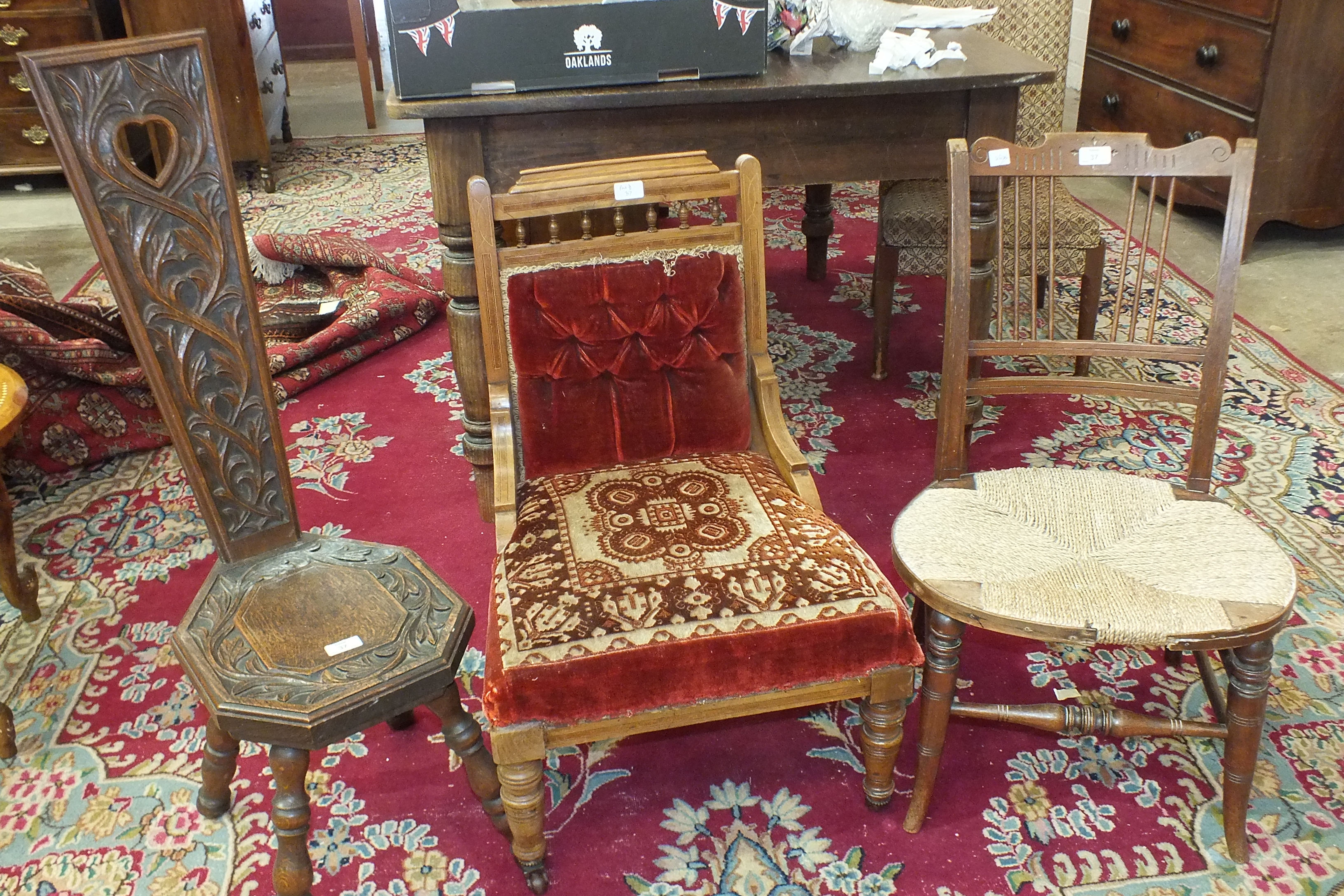 An oak spinning chair, an inlaid mahogany nursing chair and an Edwardian cord-seated chair, (3).