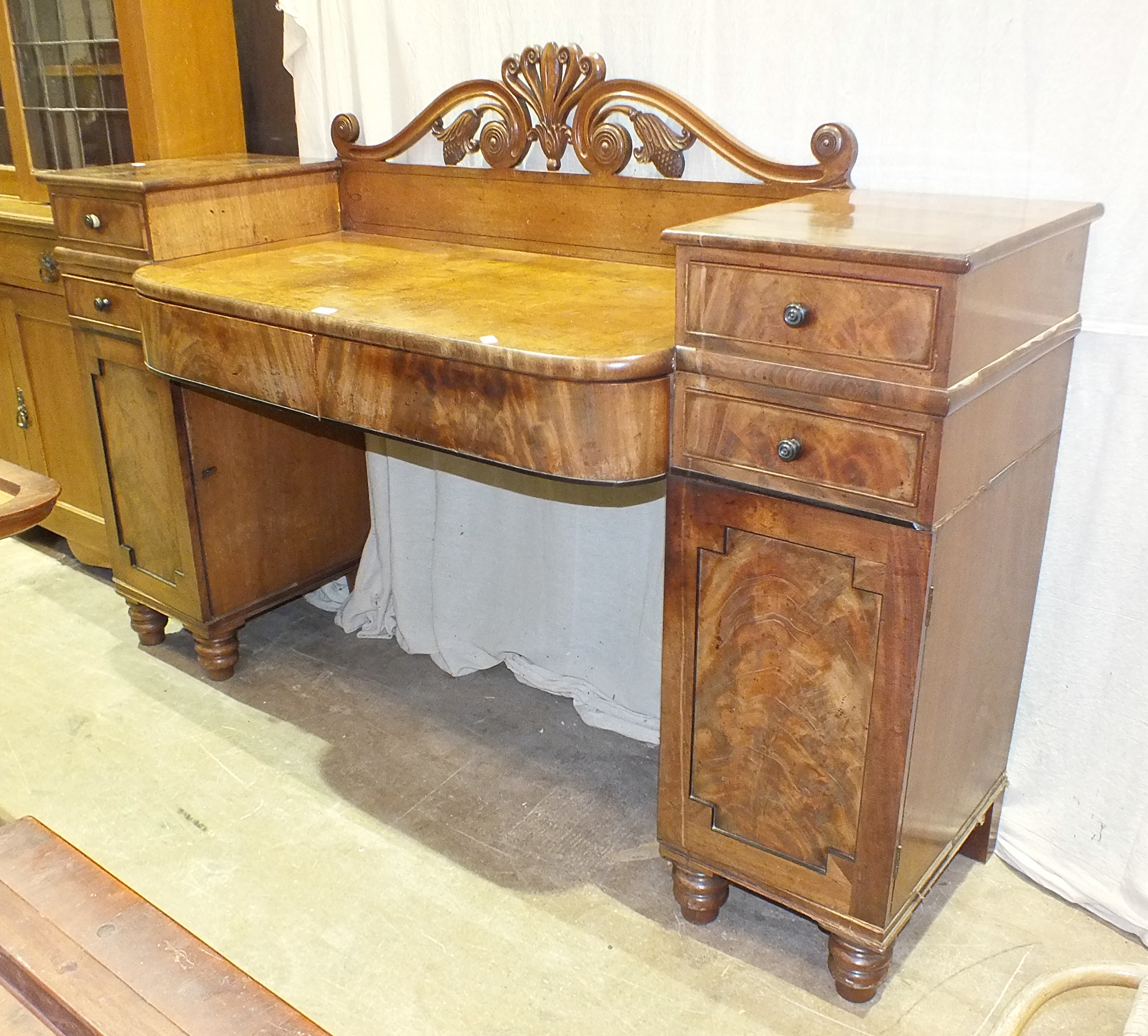 An early-19th century mahogany pedestal sideboard, having an arrangement of drawers and cupboard