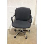A Norwegian-made office swivel chair on chrome finish quadruped support.