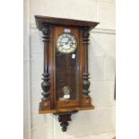 A late-19th century stained wood Vienna-style striking wall clock, 76cm high.