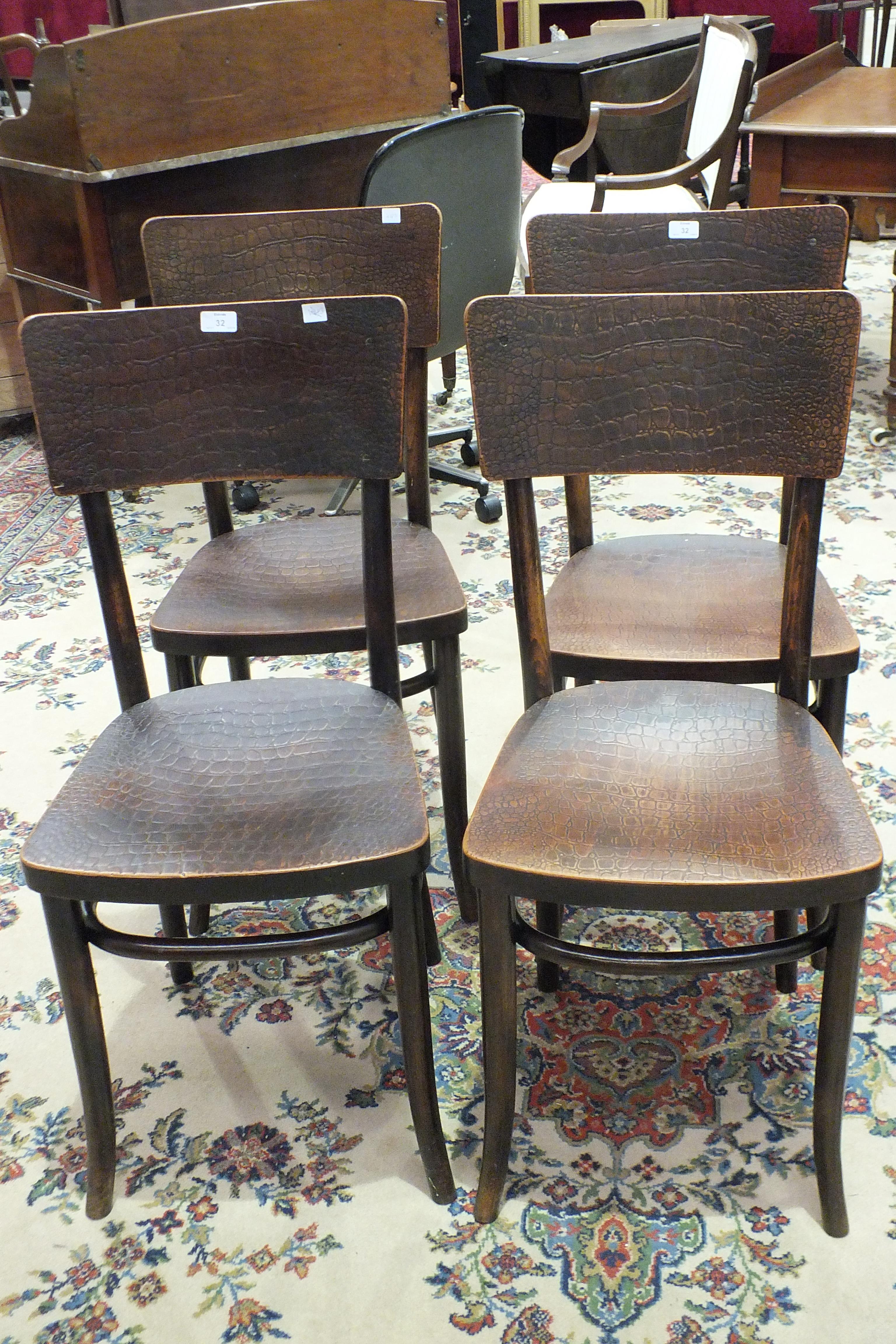 A set of four bentwood dining chairs with textured plywood seats and backs.