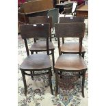 A set of four bentwood dining chairs with textured plywood seats and backs.