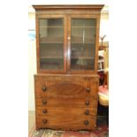 A Georgian mahogany secretaire bookcase, the pair of glazed doors above a fitted writing drawer