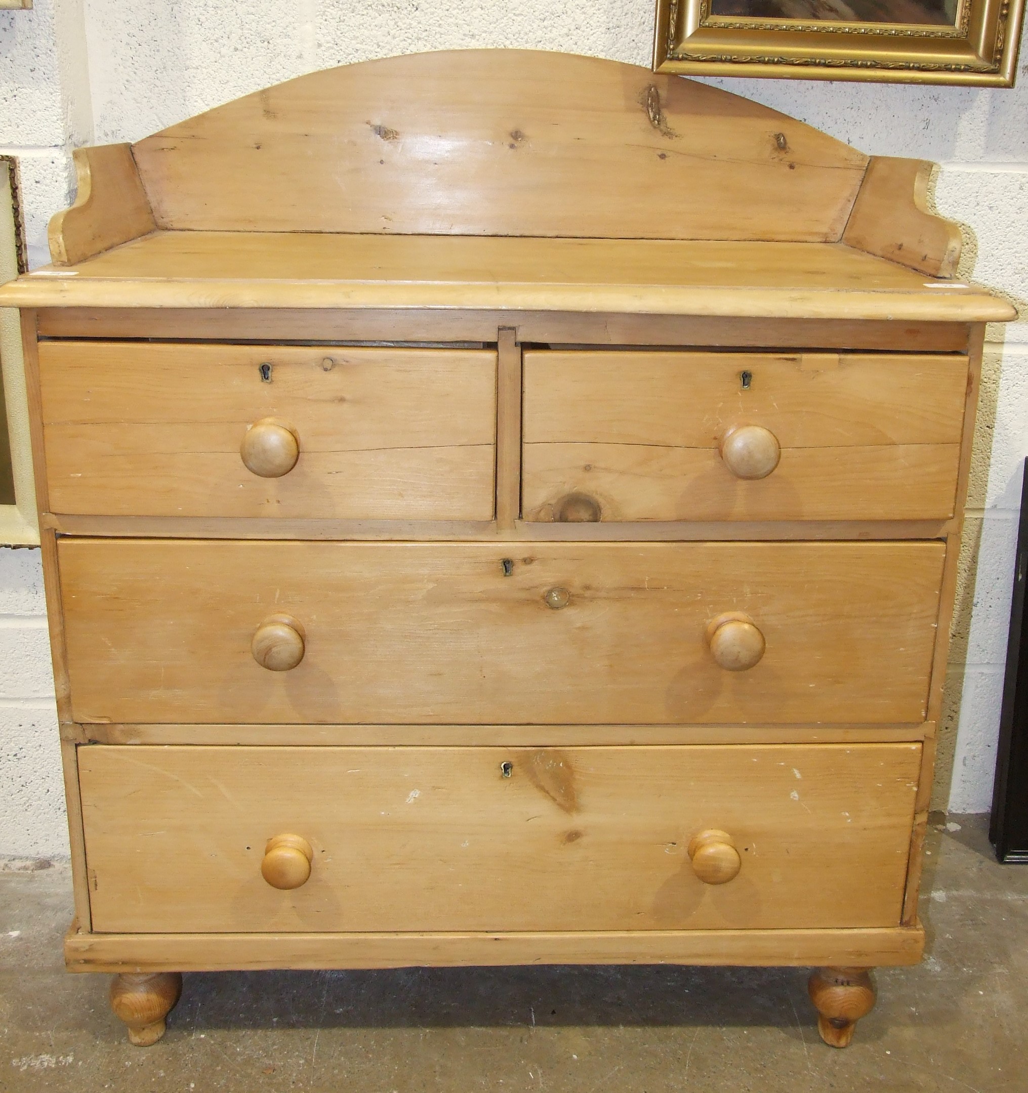 A stripped pine chest of drawers, the rectangular tray top above two small and two long drawers,