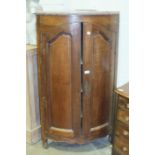 A late-19th century Continental oak corner cupboard fitted with a pair of fielded panelled doors,