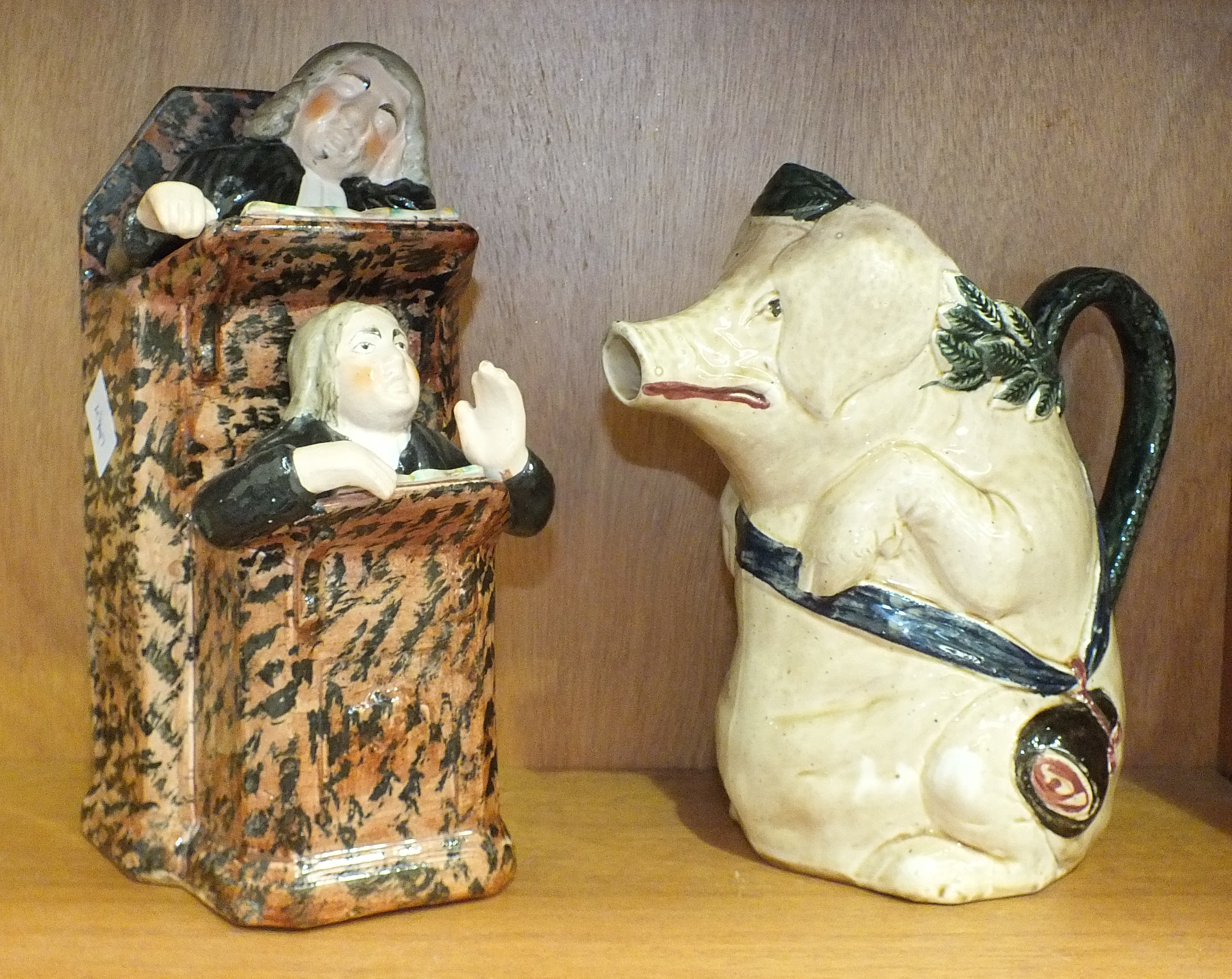 An Orchies-style vintage French majolica pitcher in the form of a pig carrying a ham on a sash