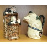 An Orchies-style vintage French majolica pitcher in the form of a pig carrying a ham on a sash