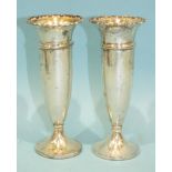 A pair of silver spill vases with loaded bases, Birmingham 1914, 13.5cm high, (2).