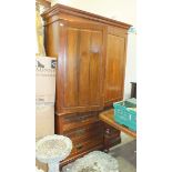 An Edwardian walnut linen press, the cornice above a pair of doors enclosing trays, two short and
