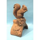 A modern terracotta roof tile ridge finial depicting a squirrel, 17cm wide 40cm high.