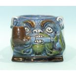 A CH Brannam Barum ware pot in the form of a Bulldog holding a pipe between its teeth, in a blue/