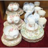 Thirty-eight pieces of Royal Doulton floral-decorated tea ware, various commemorative mugs and