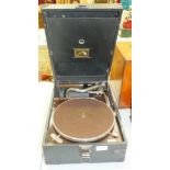 An HMV portable gramophone and a quantity of 78RPM records.