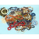 A quantity of hardstone bead jewellery, an amber-type bracelet and other items.