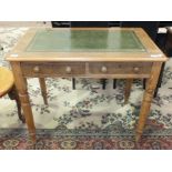 A stained pine two-drawer writing table, the rectangular top with inset writing surface, on turned