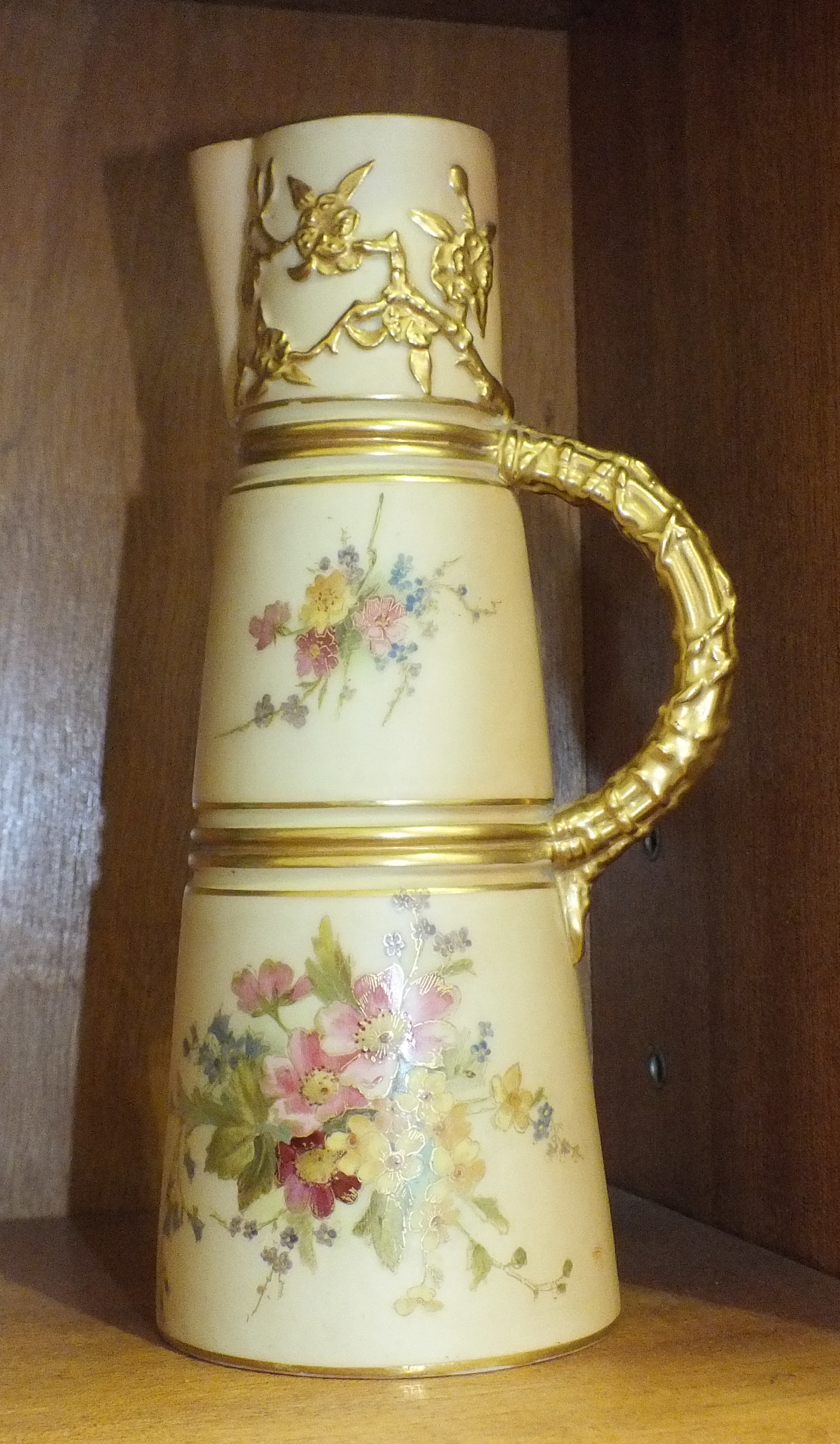 A Royal Worcester blush ivory tapering cylindrical jug, printed and painted with flowers in