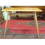 An Ercol breakfast table, the rectangular top above an open shelf, on splayed, turned and tapered