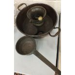 A large copper two-handled pan, 51cm diameter, a bronze skillet and other items.