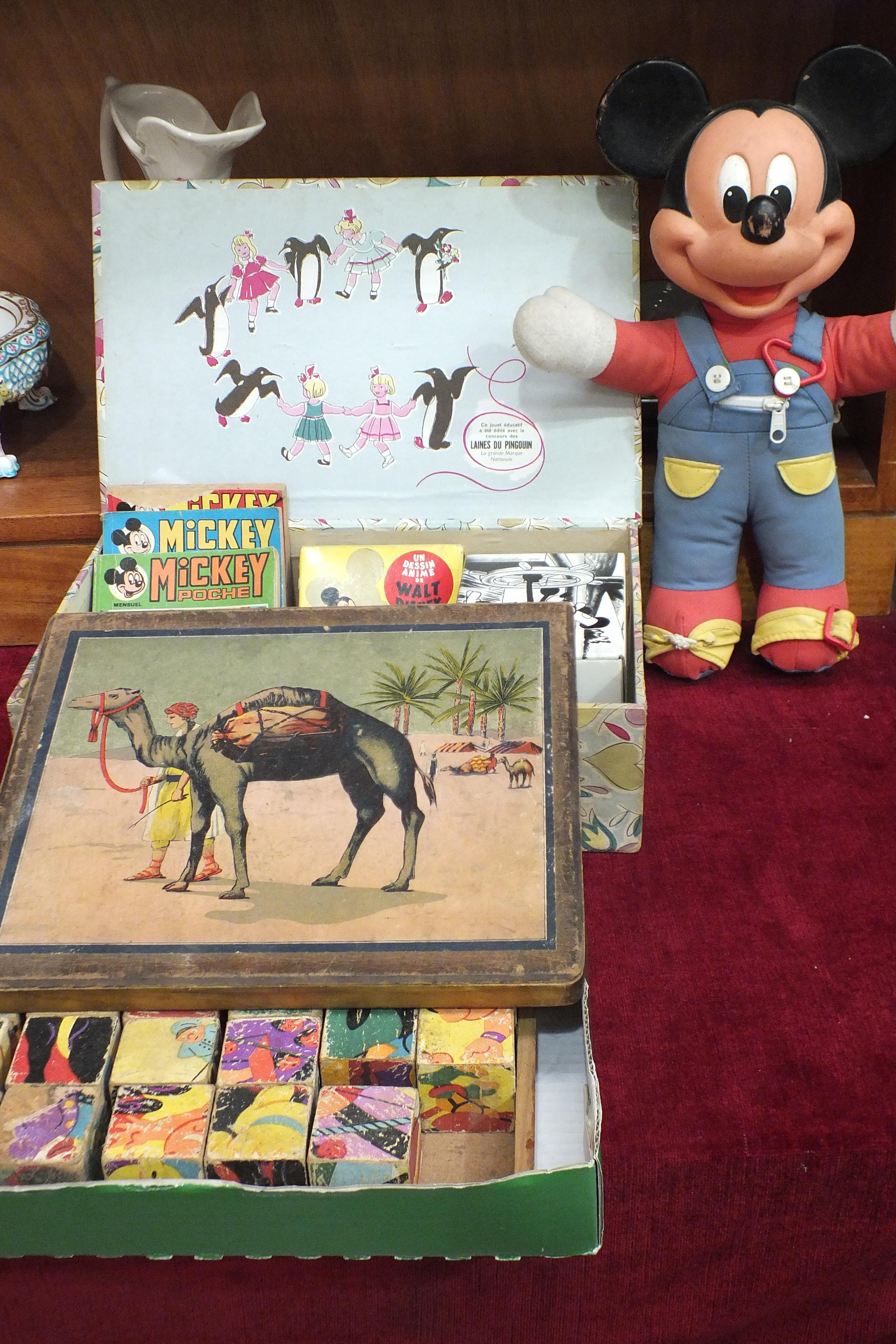 A Disney Mickey Mouse soft toy, two French Disney films and three similar books, a set of building