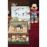 A Disney Mickey Mouse soft toy, two French Disney films and three similar books, a set of building