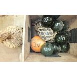 A collection of eight green glass fishing floats, three clear glass floats in net and a rum