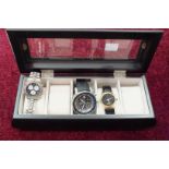 A gent's Vostok Europe H3/T25 wrist watch and two others in a glazed watch box.