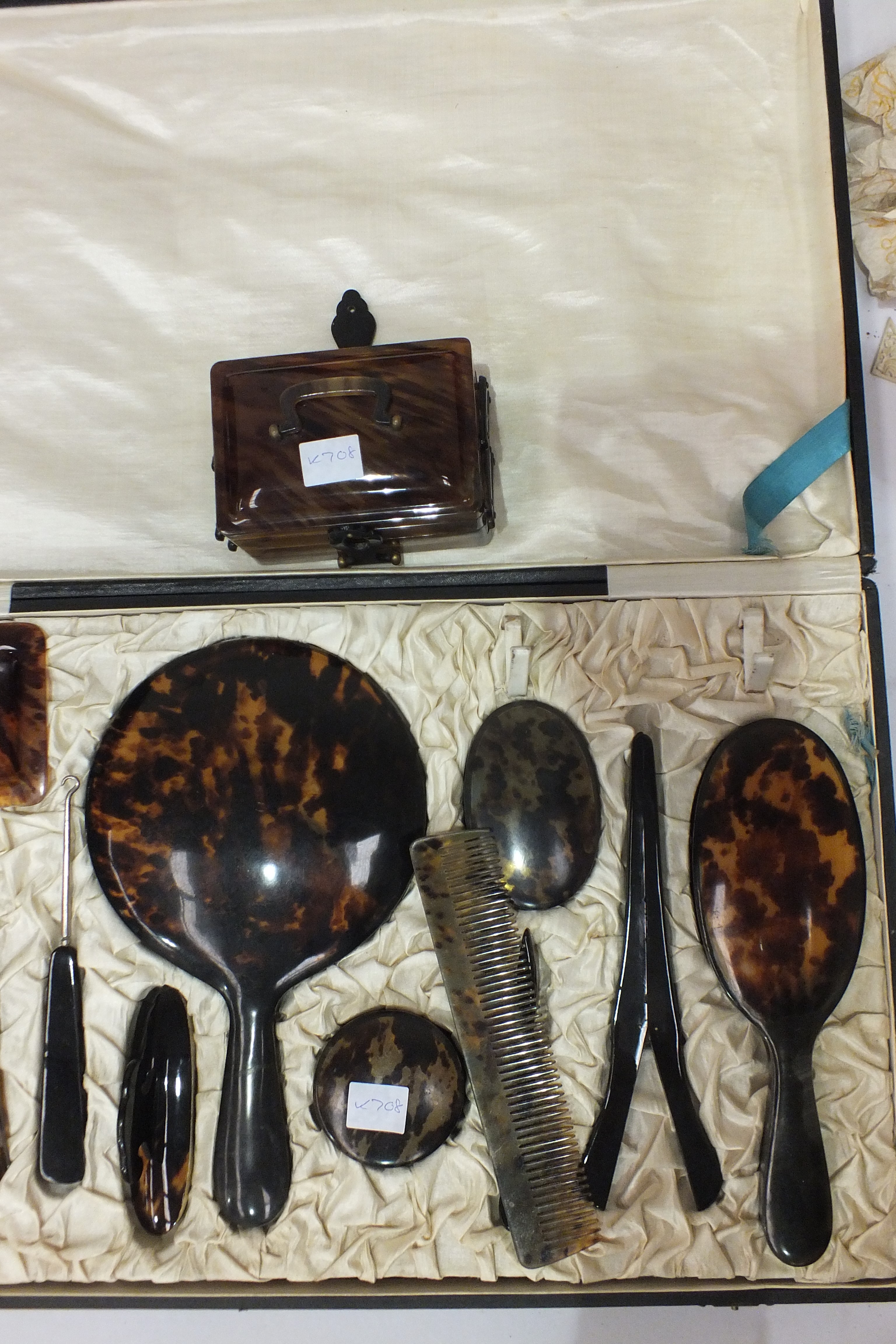 A tortoiseshell dressing table set in fitted case and a small artificial tortoiseshell jewellery