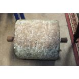 A small granite roller with iron lugs, 29cm long.
