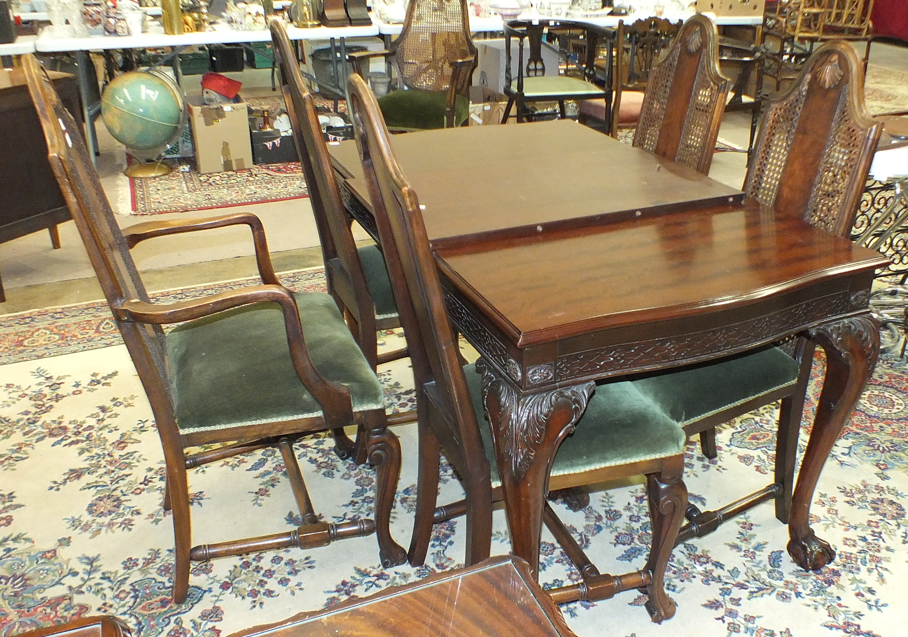 A set of five late-20th century walnut finish dining chairs with carved backs and upholstered seats,