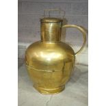 A large brass jug of rounded form, with lid and handle, 50cm high.