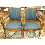 A pair of upholstered and stained beech reproduction armchairs, (2).