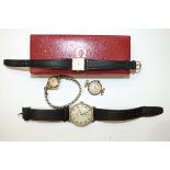 A lady's 9ct-gold-cased Omega wrist watch, boxed, two other gold-cased wrist watches, one 14ct,