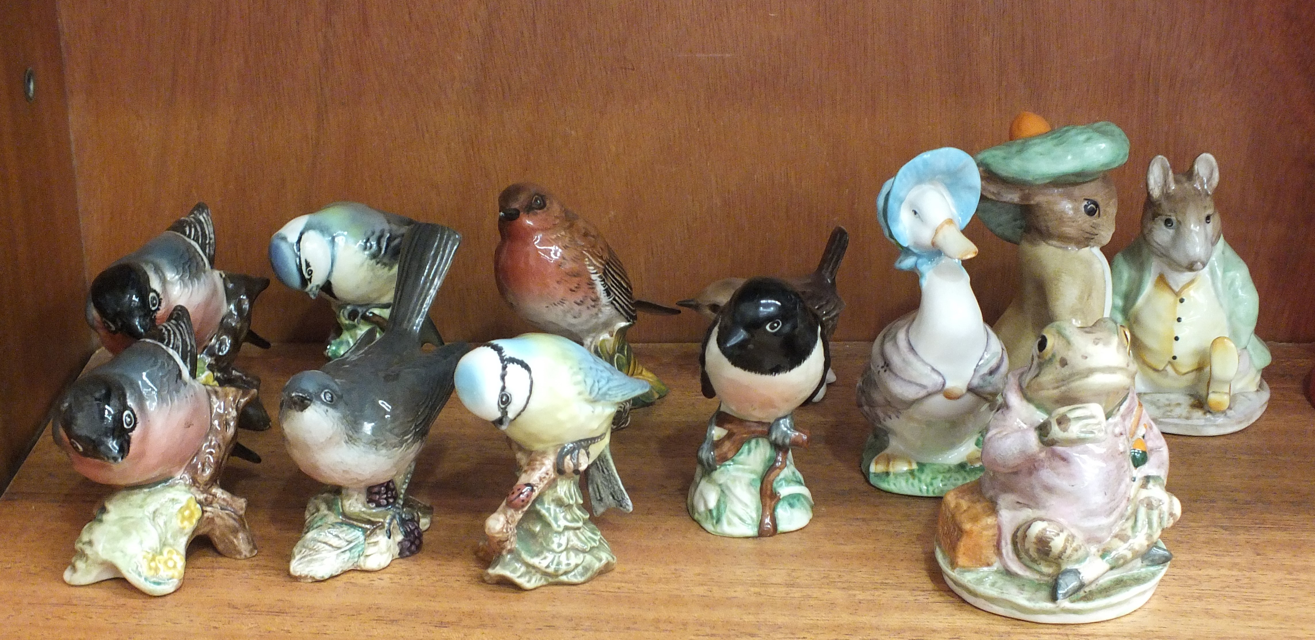 A collection of seven Beswick small bird models: Whitethroat, Bullfinch (x2), Blue Tit (x2),