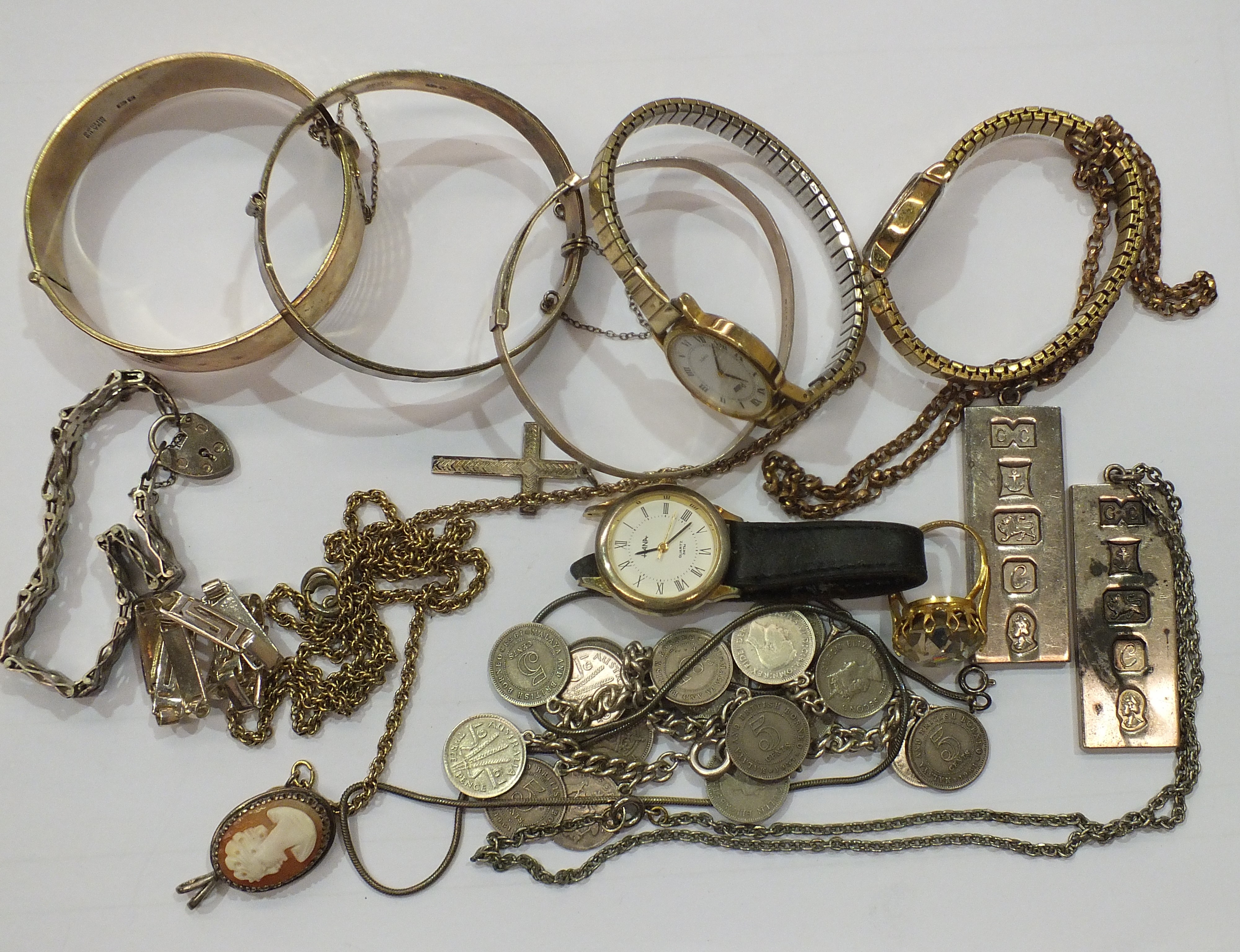 Two gold-plated silver hinged bangles, two silver ingots and other items.