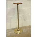A brass torchère stand with turned wood top, 90cm high.