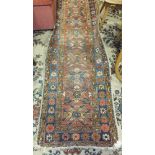 An Eastern runner with geometric and floral decoration, 252 x 70cm, (a/f, worn).