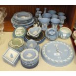 A collection of sixty-eight pieces of Wedgwood blue and white jasperware, including a wall clock,