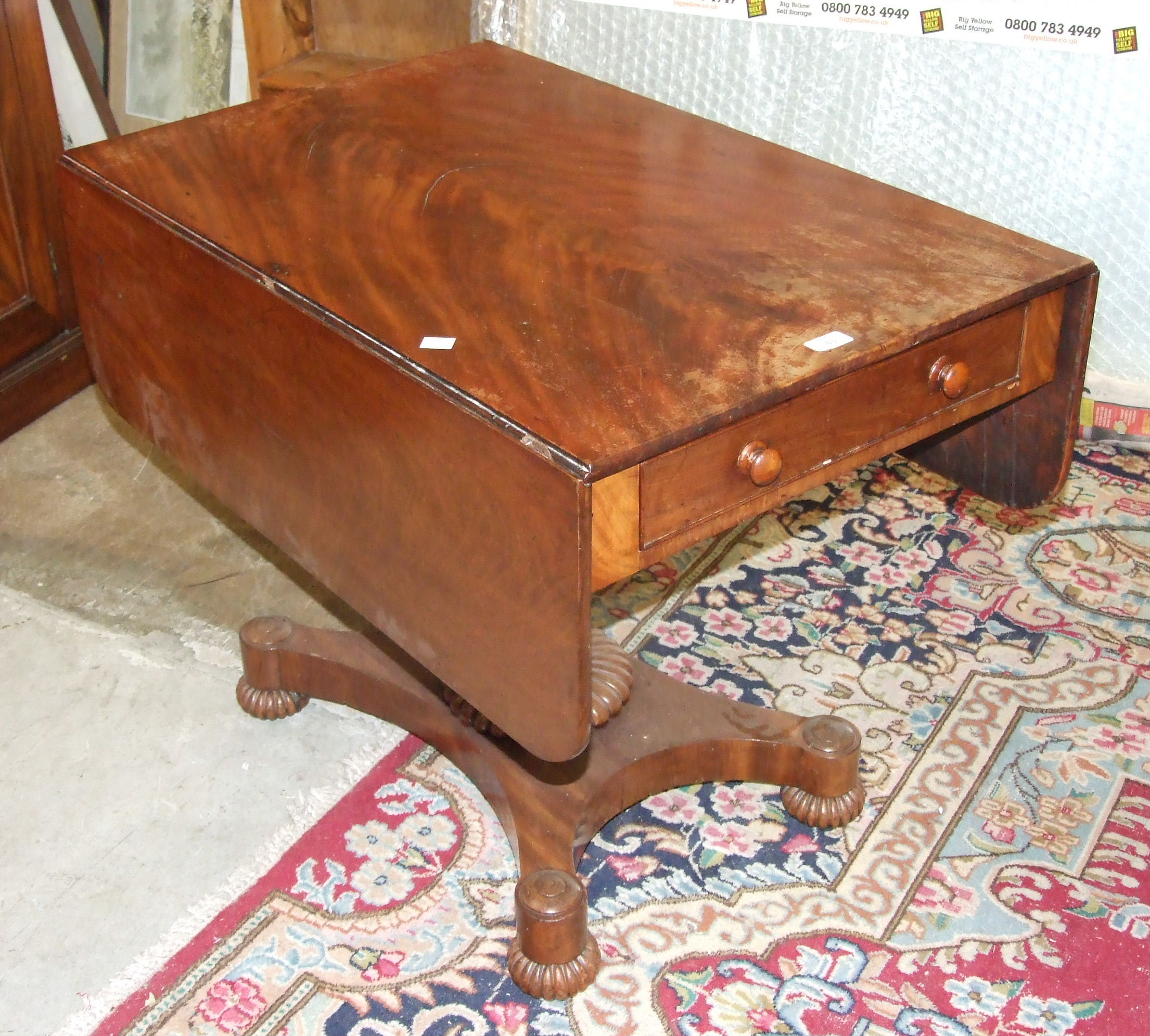 A Victorian drop-leaf breakfast table, the rectangular top above an end drawer, on turned column and