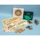 A collection of various British and world coins and bank notes, together with four standard
