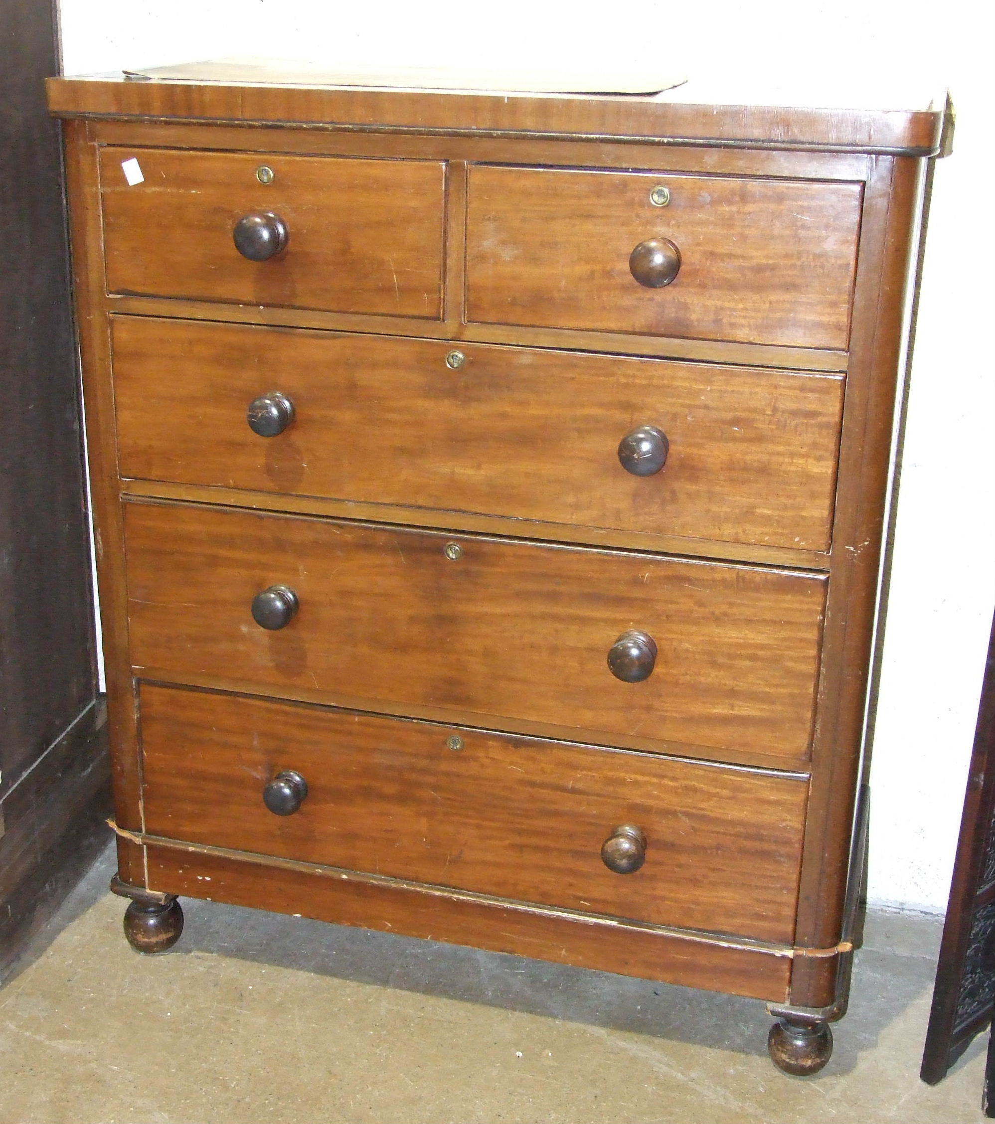 A late-19th century mahogany finish rectangular chest of two short and three long drawers, on turned