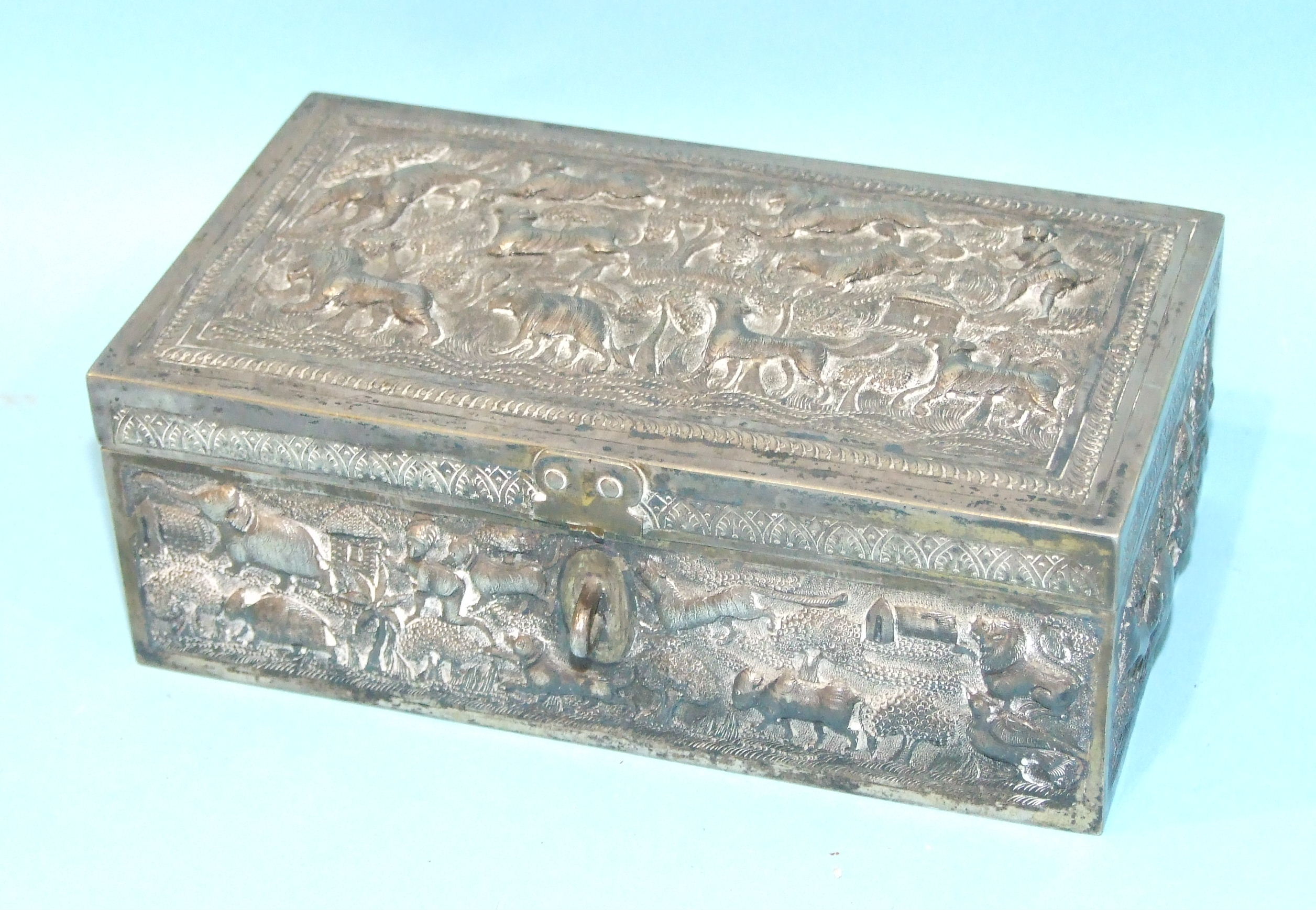 An Indian white metal box embossed with wild animals, (a/f).