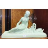 A green ceramic Art Nouveau figure of a woman with a swan, 58cm long, 32cm high and an Art Nouveau-