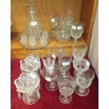 A cut-glass decanter with stopper and four matching liqueur tumblers, on circular tray, a cut-