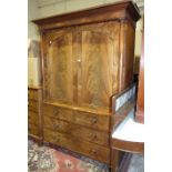 A Victorian mahogany linen press, having a pair of panelled doors above two short and two long