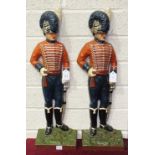 Two 20th century painted cast metal door stops of figures in military uniform, 61cm high, (2).