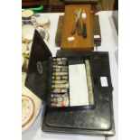 A Winsor & Newton japanned metal oil paint case with paints and palette, 32.5 x 21.5cm, a similar,