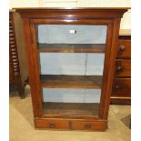 A late-Victorian mahogany display cabinet, the rectangular top above a single glazed door and two