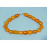 A string of orange amber-type Bakelite beads.