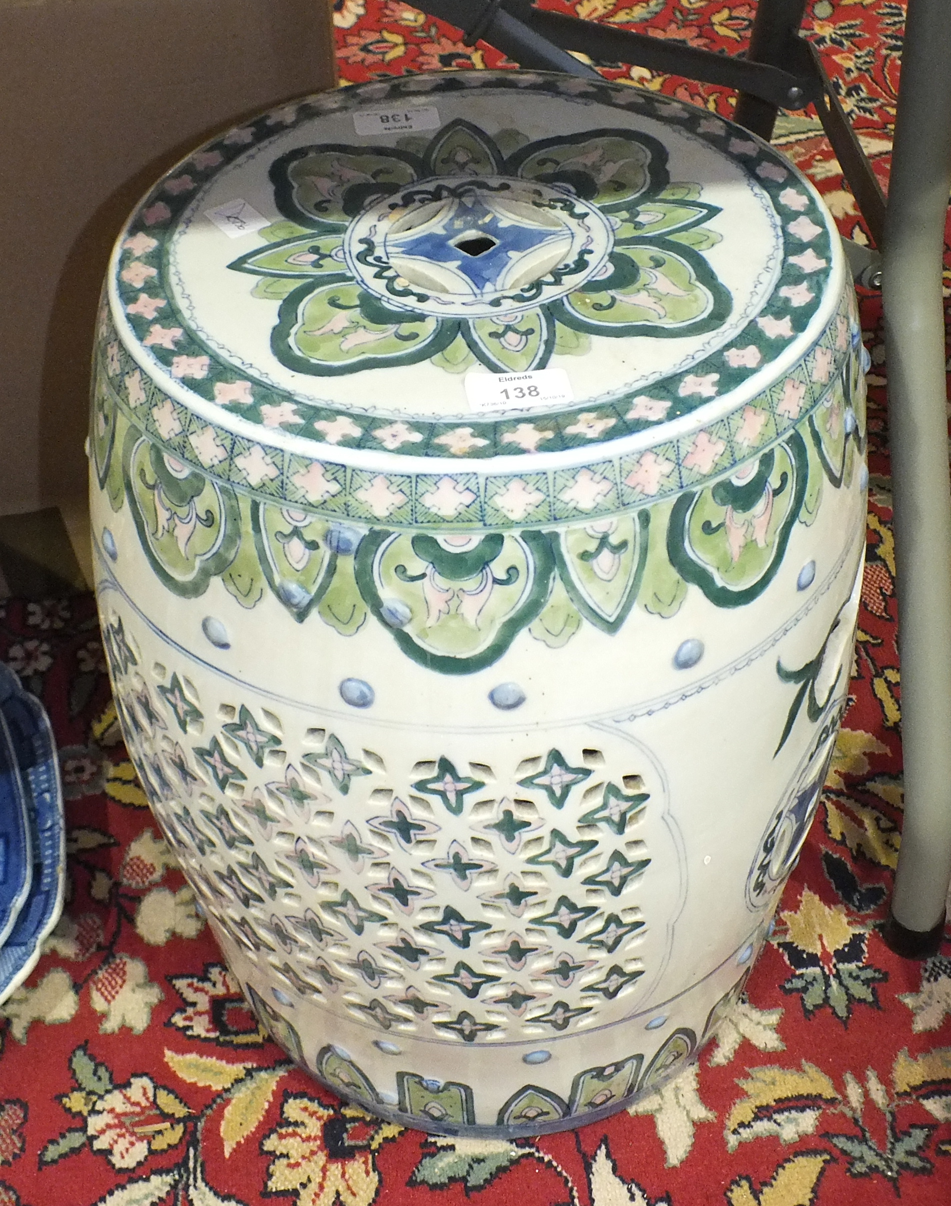 A reproduction Oriental ceramic garden seat of barrel shape, 45cm high.